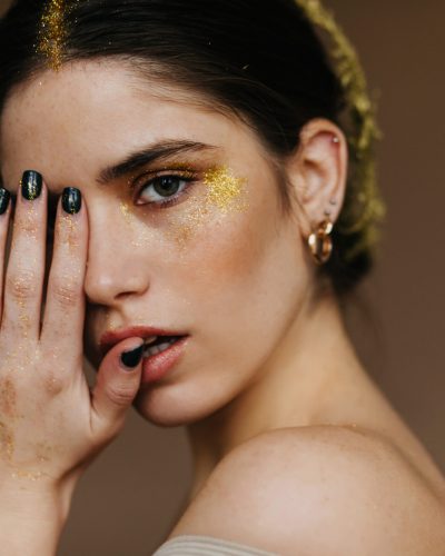 Close-up studio photo of attractive girl. White interested woman posing in golden