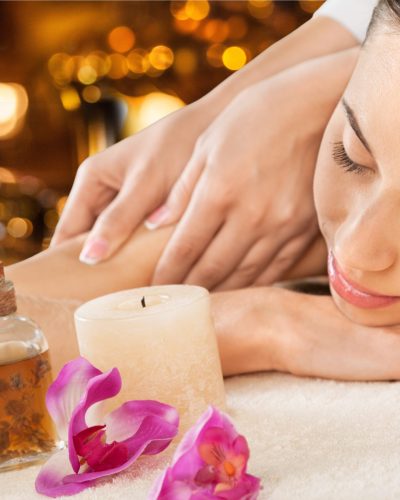 Masseur doing massage on woman body in the spa salon. Beauty treatment concept.
